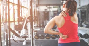 woman in back pain after strength training