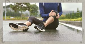 woman with joint pain sitting on the road
