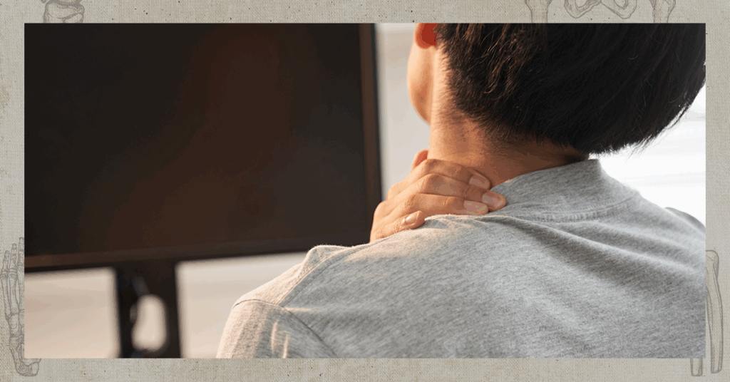 Man in front of flatscreen TV rubbing his neck.